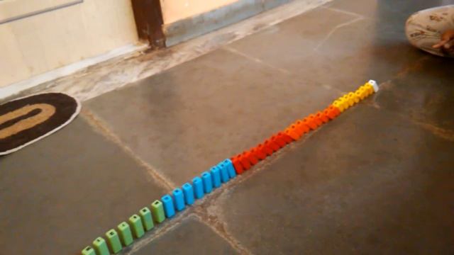 Brick buster game's parts used as dominos in slow motion.
