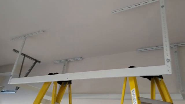 Overhead garage storage rack installation