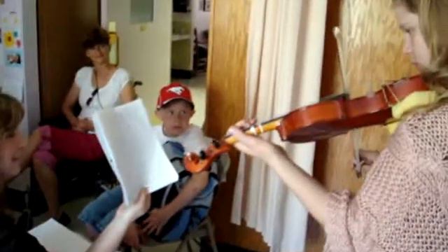 Jessica playing violin for Gramma Watchuk