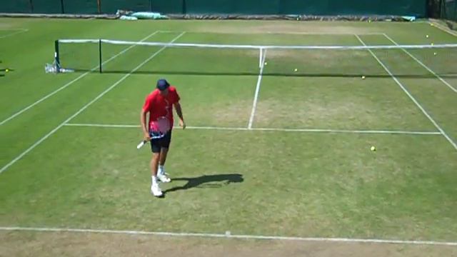 Chris Eaton practises his serve at Wimbledon