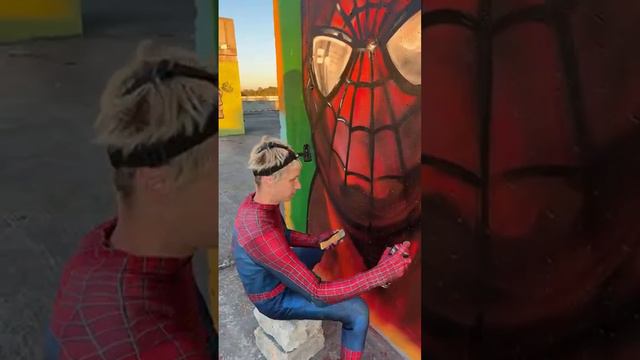 Spiderman draws graffiti