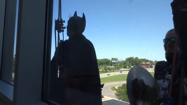 Superheroes wash windows of Illinois children's hospital