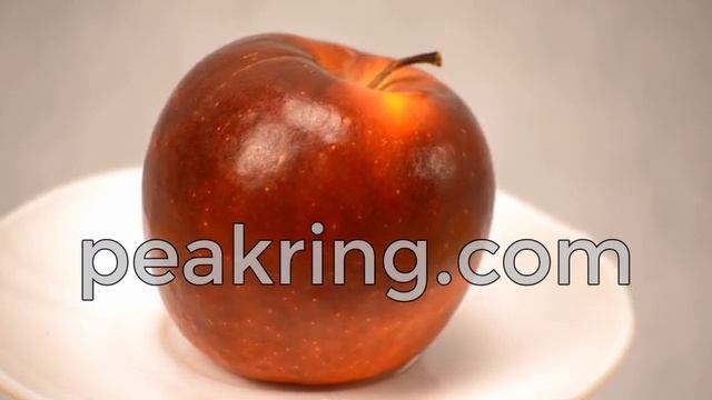 A Ripe Red Apple Rotating On A Plate - Peakring Footage