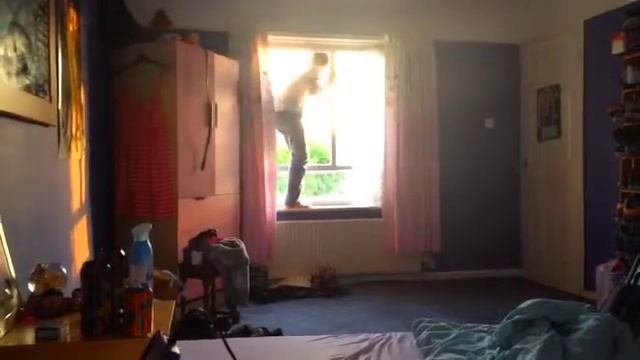 Alex climbing out the window