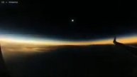 Watch from an airplane window as the moon's shadow moves over the Earth during a total ...