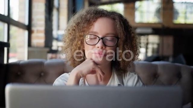Girl in Glasses for Vision Looks Out Window While Working at Laptop | Stock Footage - Envato ele...