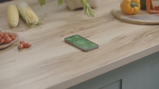 Free iPhone 14 pro Green screen footage 4k _ iPhone with blank green screen on kitchen table desk