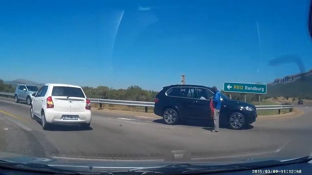Hartebeespoort Barrier while son standing on back seat