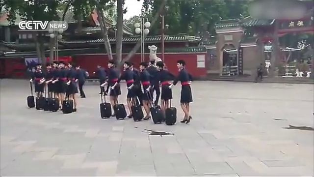 Stewardesses dance outside ancient Chinese temple