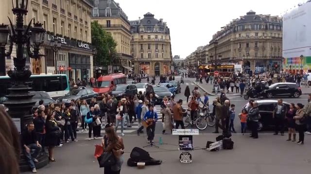 Guy singing in front of Palais Garnier