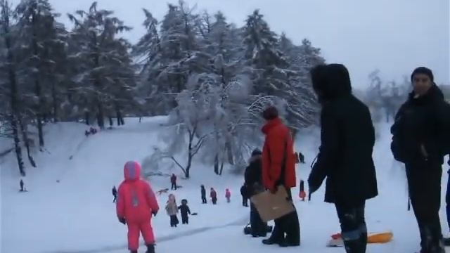 Summit with kids on a snowy hill.AVI