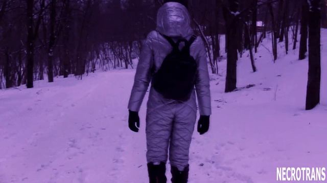 Winter walk under snow and in the snow in winter ski overalls snow suit with deep hood and mask