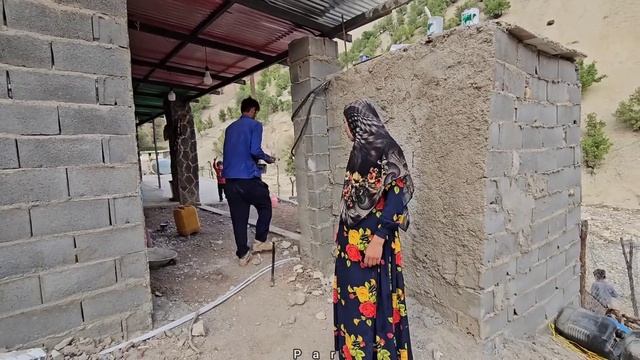 rural life . Babak paints the doors and windows of the kitchen and bathroom