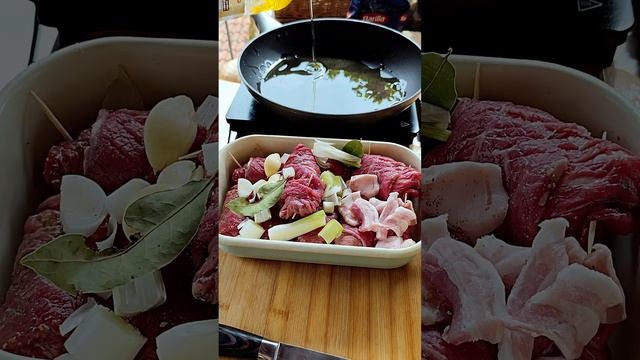 rolled beef with onion, pickled cucumber, bacon