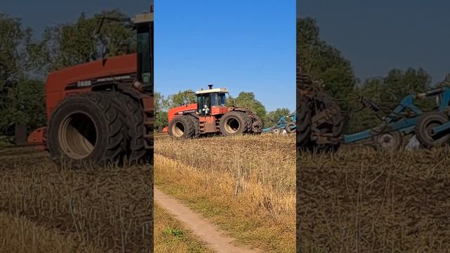 A large tractor plows a field