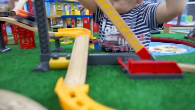 A child rides on a carousel and runs on the playground