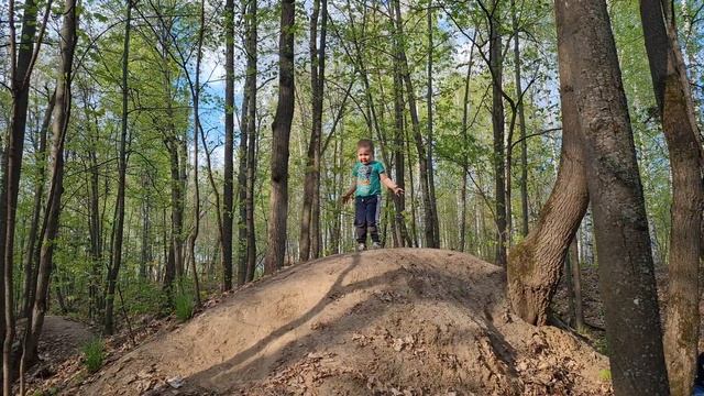 A child on a mountain jumps for joy