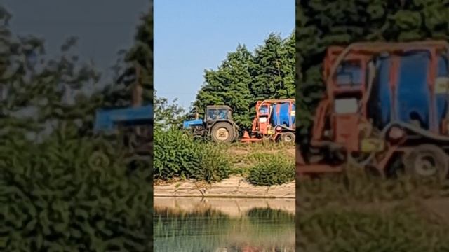 A tractor carries a barrel to work