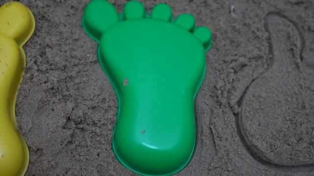 Playing in the sandbox with beach toys and making turtle molds out of sand