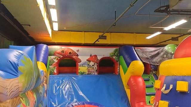 A child slides down a slide on a playground