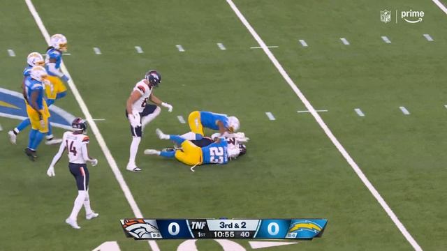 Javonte Williams evades pressure with a 15-yard dash up the middle