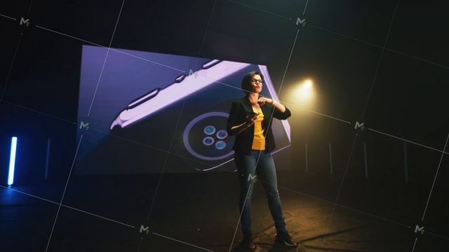 Woman demonstrating smartphone and smart watch on stage