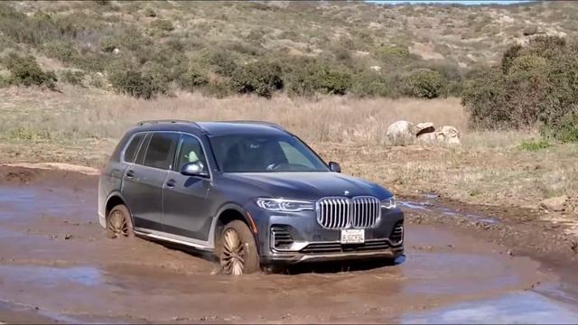 BMW X7 crossing a mud puddle