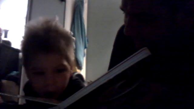 Paz Felix Jimenez reading with his daddy