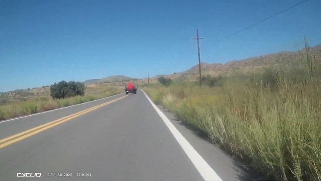 RED TANK TRUCK - LEANING ON HORN WHEN PASSING BICYCLIST