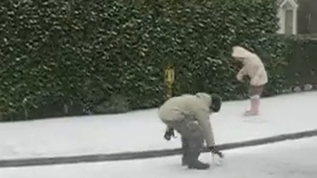 Samuel and Hannah in the snow at Lambert Drive playing with Dad