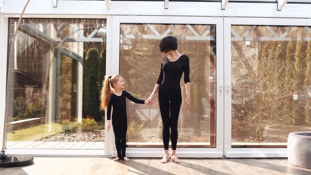 Mother And Daughter Tandem Practicing Ballet Kick