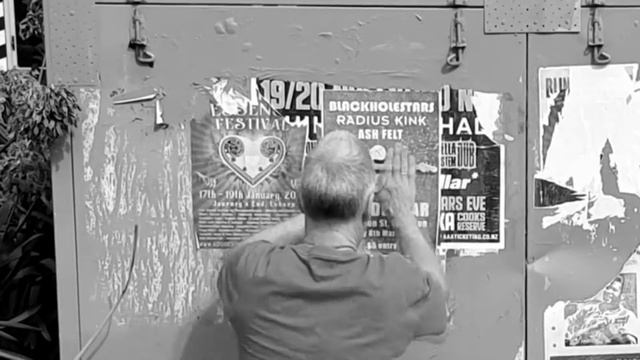 Plastering posters around the town.