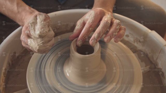 Potter special tools handles clay. Only hands and wheel, close up