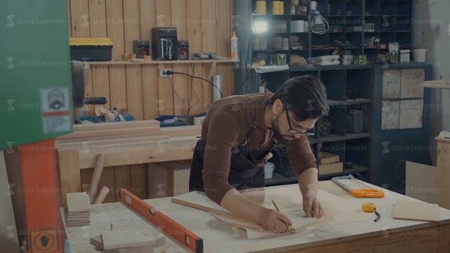 Master designs the furniture, makes markup on the wooden bar