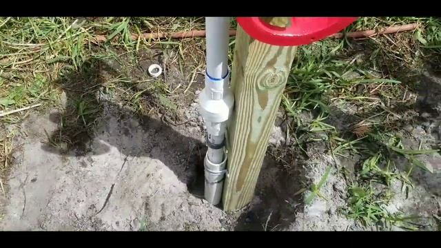 shallow well drilling with water hose for a hand pump