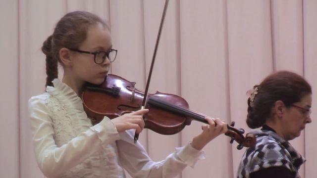 Ученики играют с аккомпанементом на сцене перед родителями