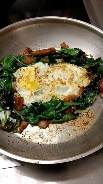 #breakfast accountability Crispy bacon bits, sautéed greens and over medium eggs