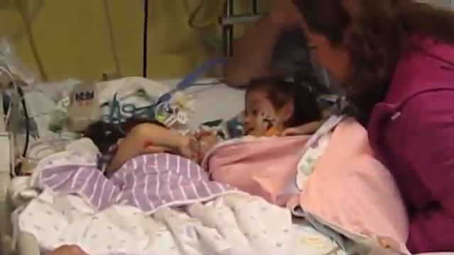 Touching moment conjoined twins are reunited after surgery