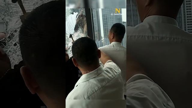 Man hangs outside 34th floor window
