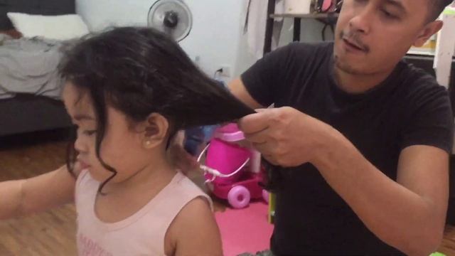 Dad ironing Ayu’s natural curly hair for the first time.