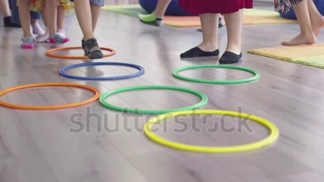 stock-footage-small-nursery-school-children-with-female-teacher-on-floor-indoors-in-classroom-doing-