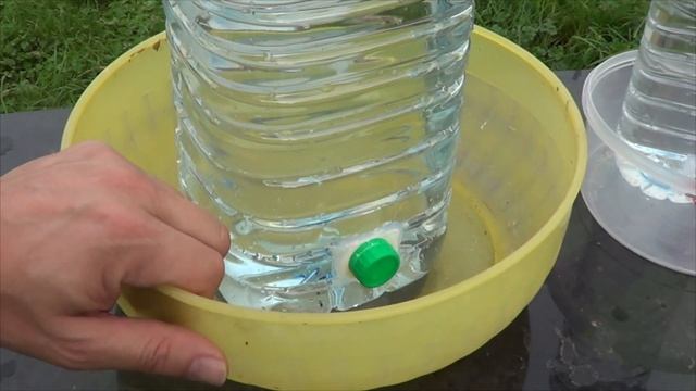 homemade drinking trough for pets and chickens made from reused plastic bottles