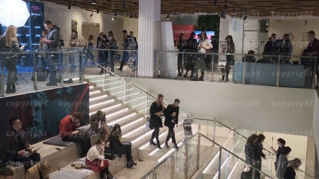 People walking down stairs in business center
