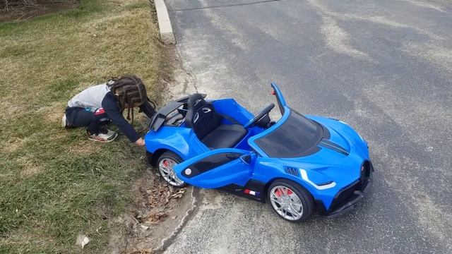 Bugatti 12v car stuck, pushed off lawn.