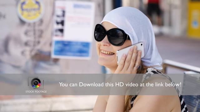 Woman in a headscarf chatting on mobile