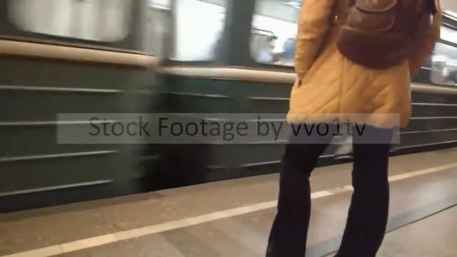 MOSCOW, RUSSIA - SEPTEMBER 16, 2018: Woman, in trousers, in an orange jacket, with a backpack on th