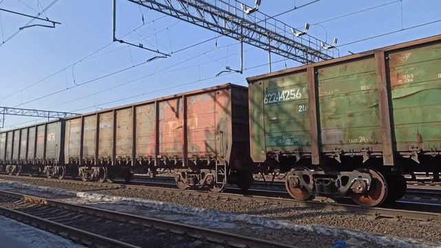 Freight train with electric locomotive 2ES4k - 047 with empty gondola cars from under coal