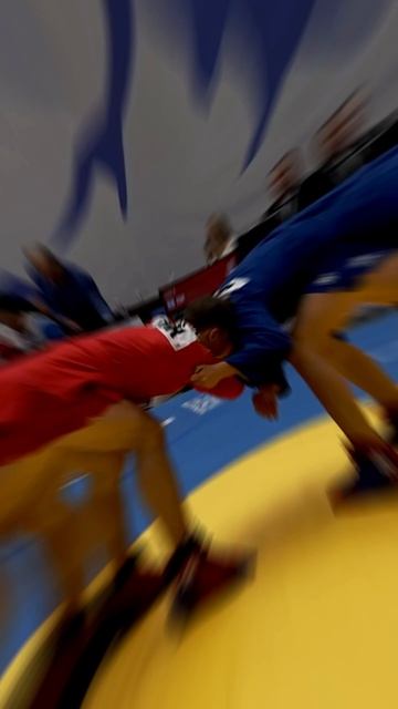 Baiel DZHAKSHYLYKOV (KGZ) expertly snatched Nikita SAVIN’s (GER) leg sending him straight to the mat