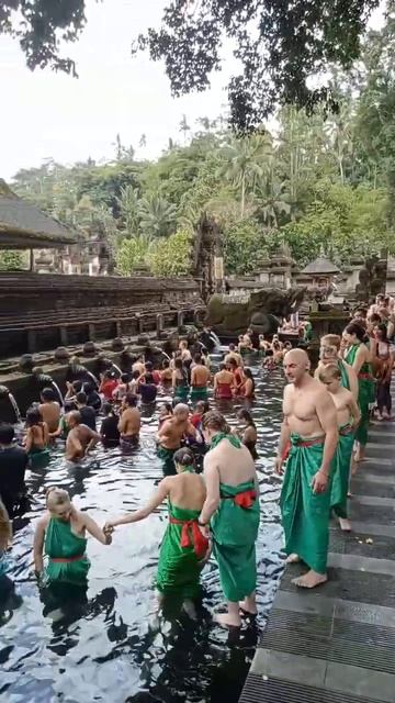 melukat (cleansing themselves from holy springs) at Tirta empul temple Tampaksiring Bali.