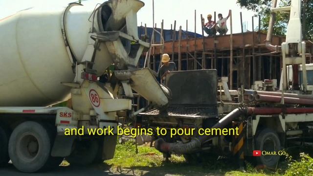 mixer truck with concrete pump working together pouring cement